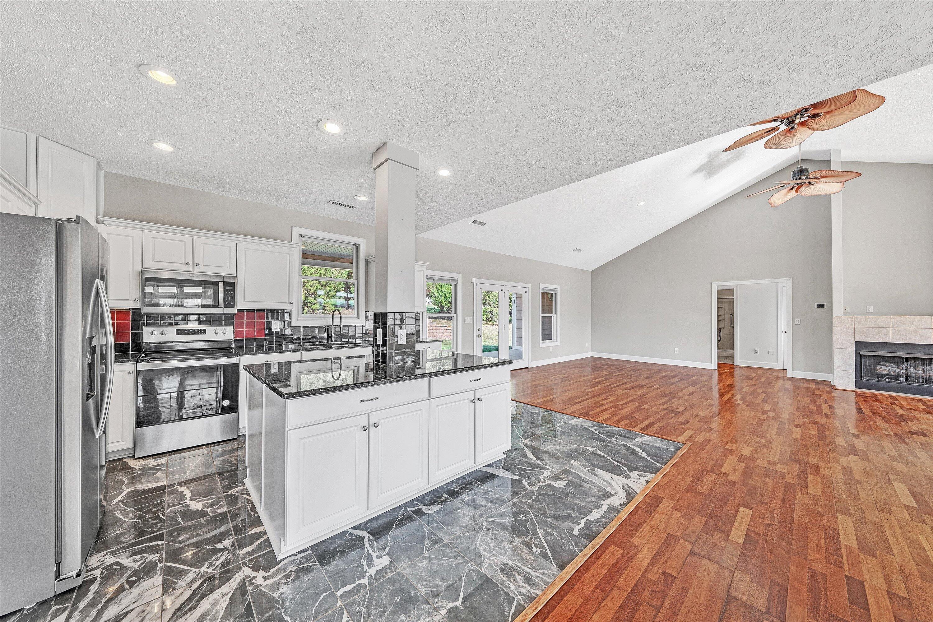 537 Calypso Road Moneta, VA 24121 - Photo 22 of 55 a kitchen with stainless steel appliances granite countertop a refrigerator and a stove top oven