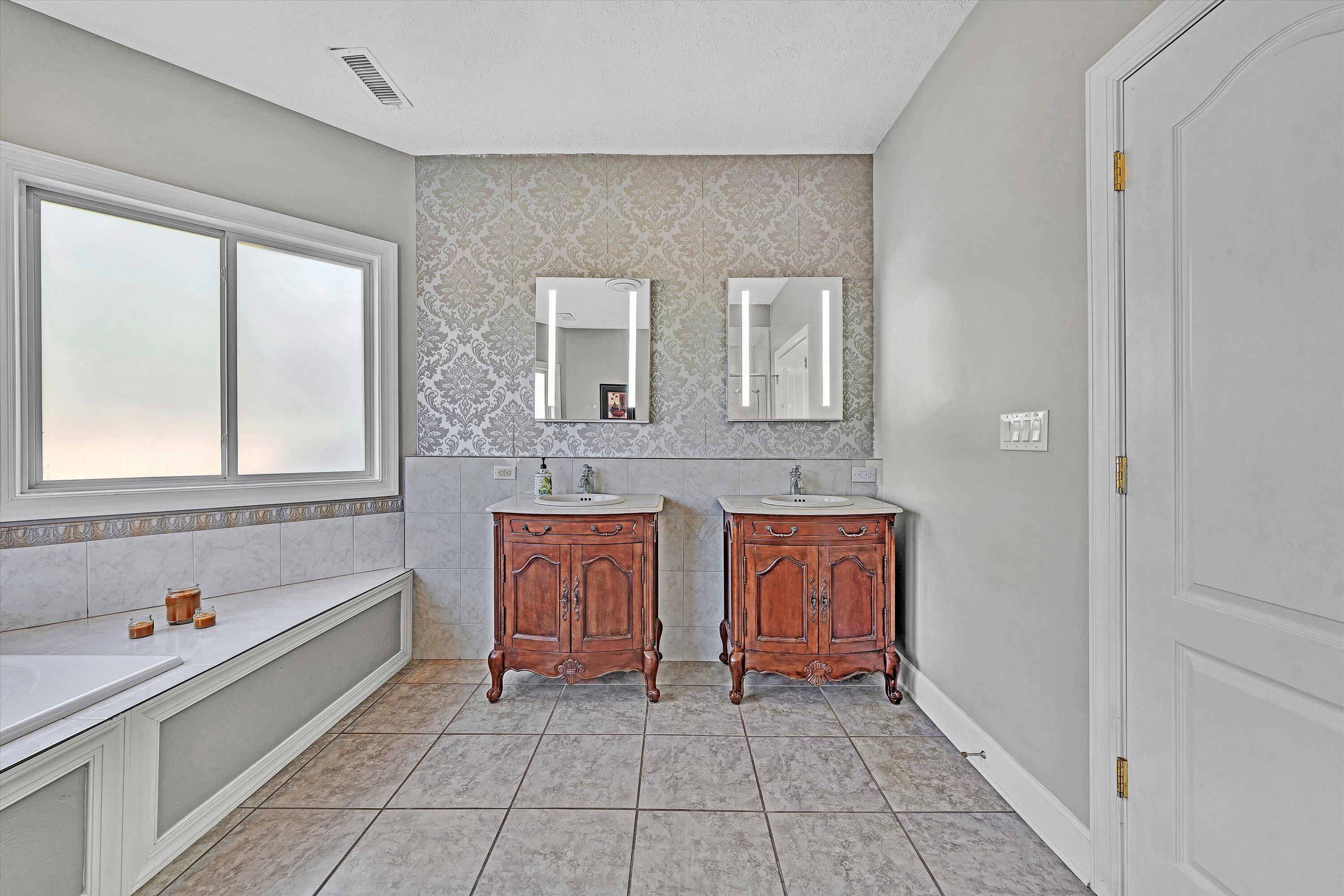 537 Calypso Road Moneta, VA 24121 - Photo 30 of 55 a spacious bathroom with a granite countertop sink mirror and bathtub