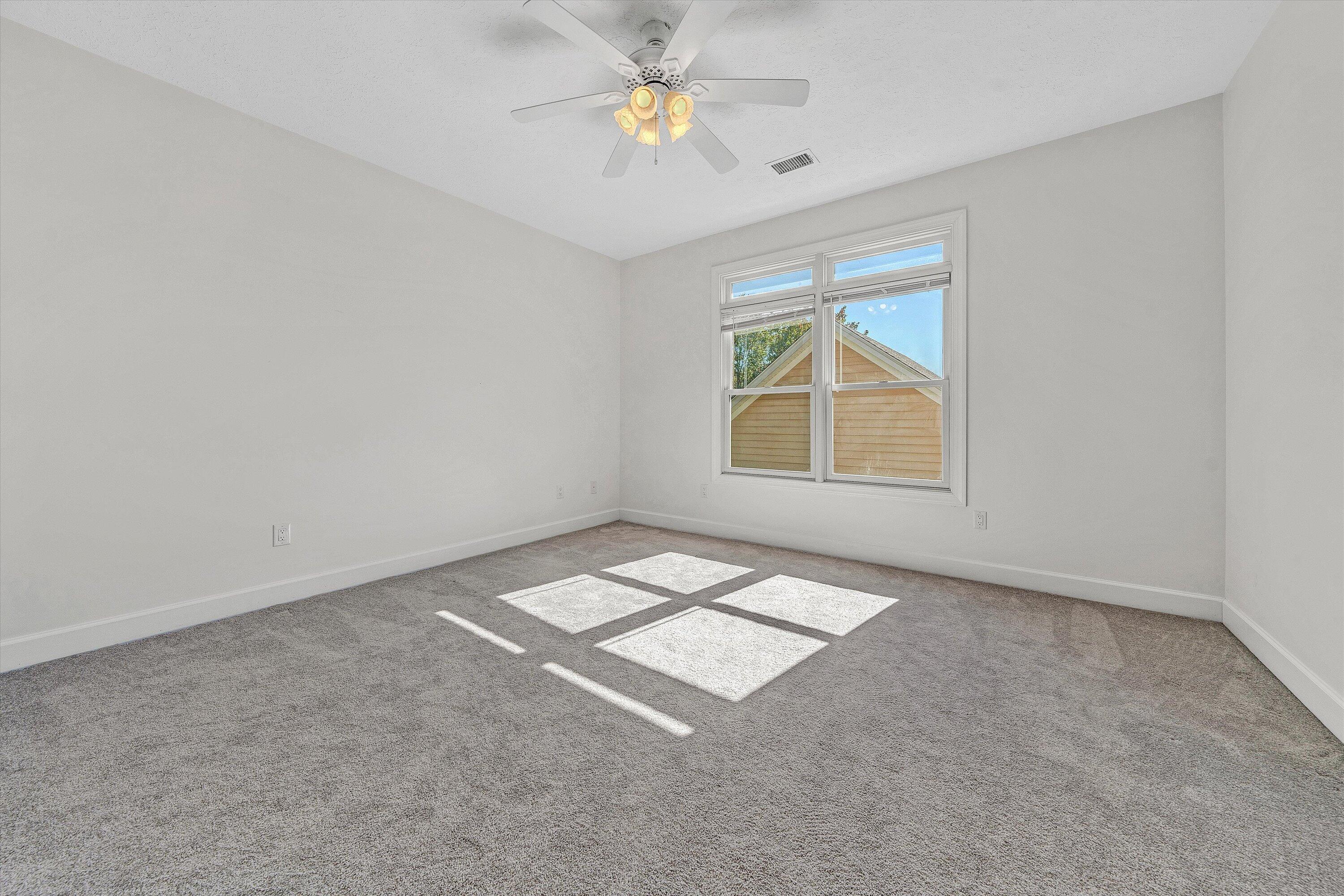 537 Calypso Road Moneta, VA 24121 - Photo 33 of 55 an empty room with windows and ceiling fan