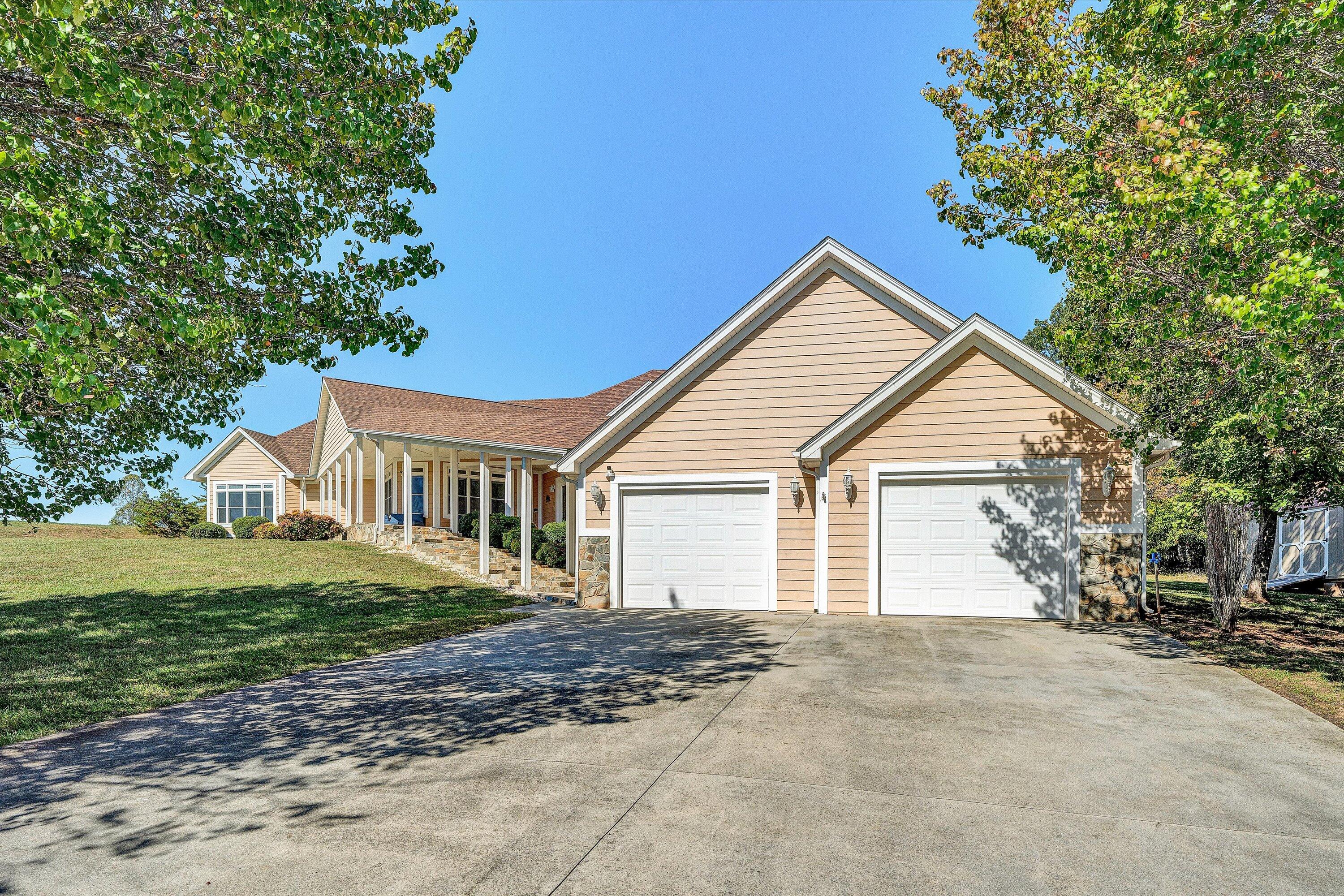 537 Calypso Road Moneta, VA 24121 - Photo 4 of 55 a view of a yard in front of a house with large trees