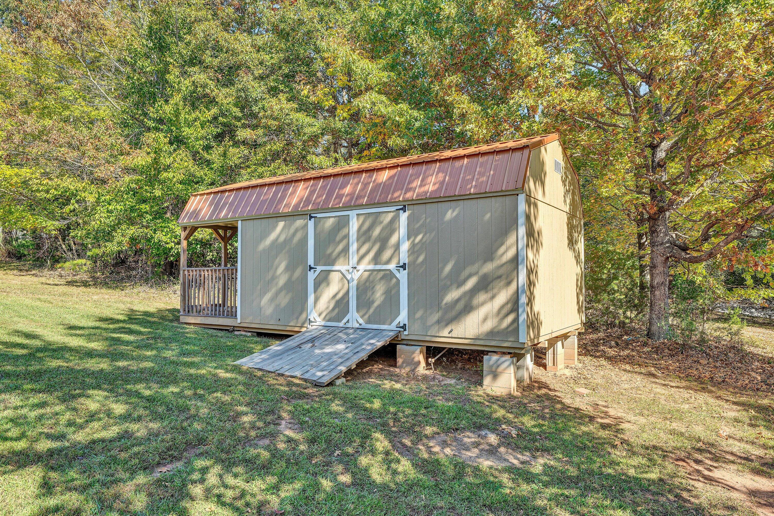 537 Calypso Road Moneta, VA 24121 - Photo 46 of 55 a view of a backyard with a small cabin
