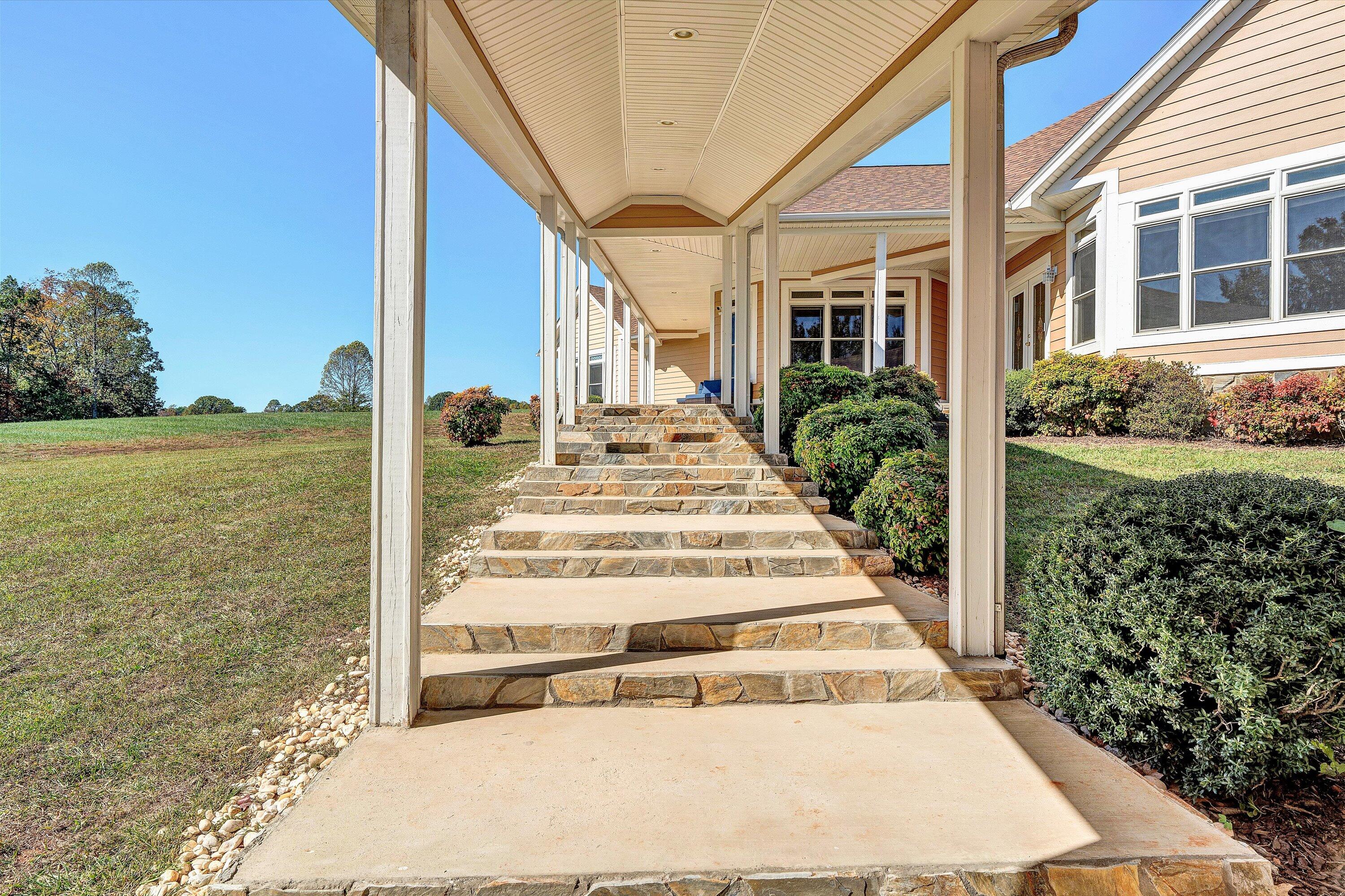 537 Calypso Road Moneta, VA 24121 - Photo 6 of 55 a view of a building with floor to ceiling windows and wooden fence