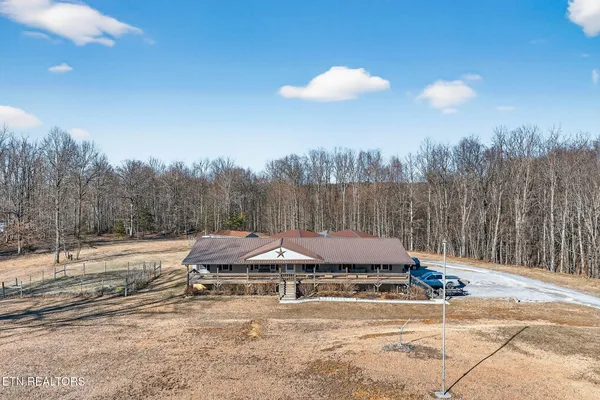 a aerial view of a house with garden space and trees