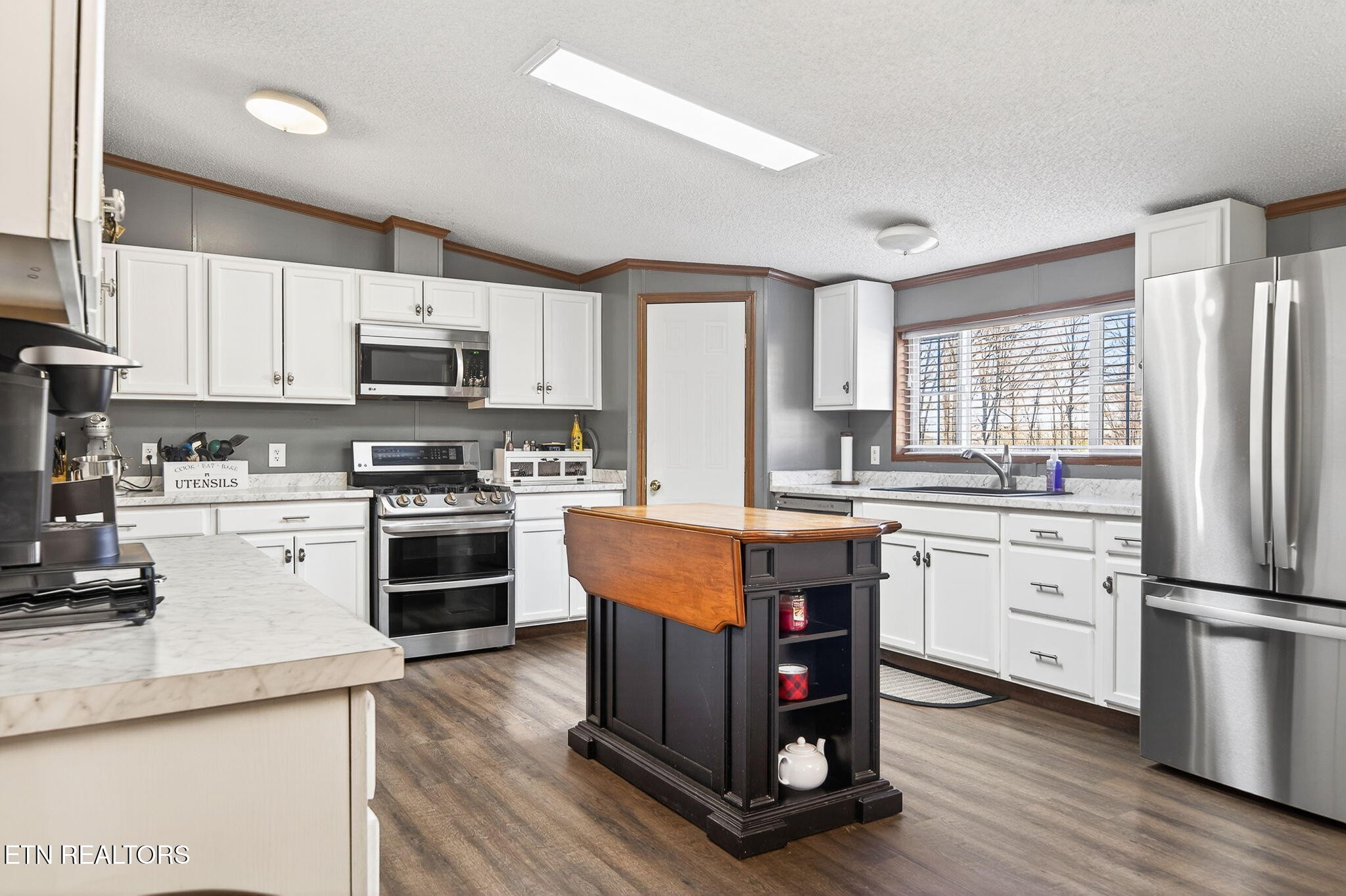 3773 Glade Creek Road Sparta, TN 38583 - Photo 4 of 59 a kitchen with kitchen island granite countertop a stove refrigerator and microwave