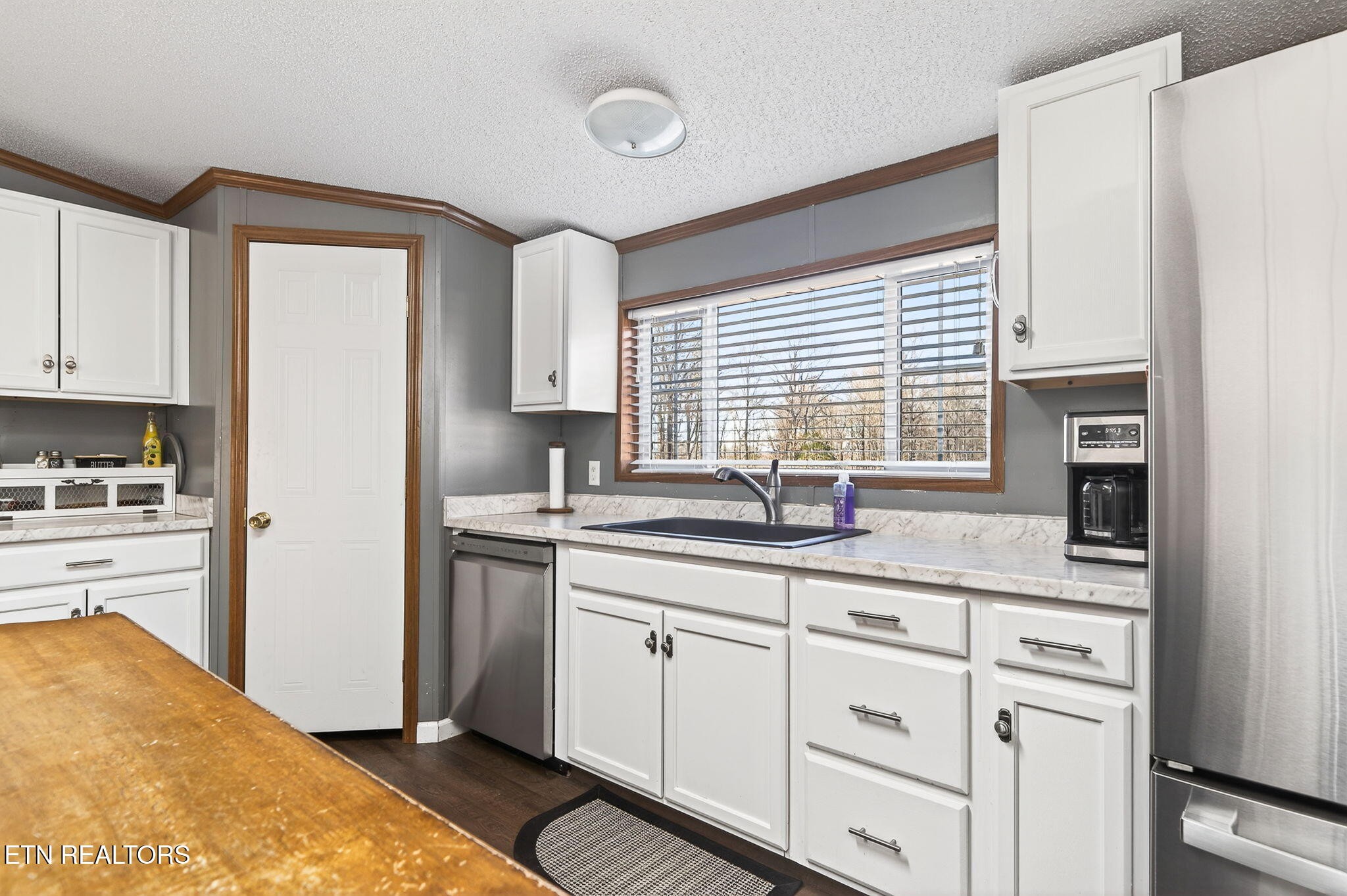 3773 Glade Creek Road Sparta, TN 38583 - Photo 7 of 59 a kitchen with granite countertop white cabinets and white appliances