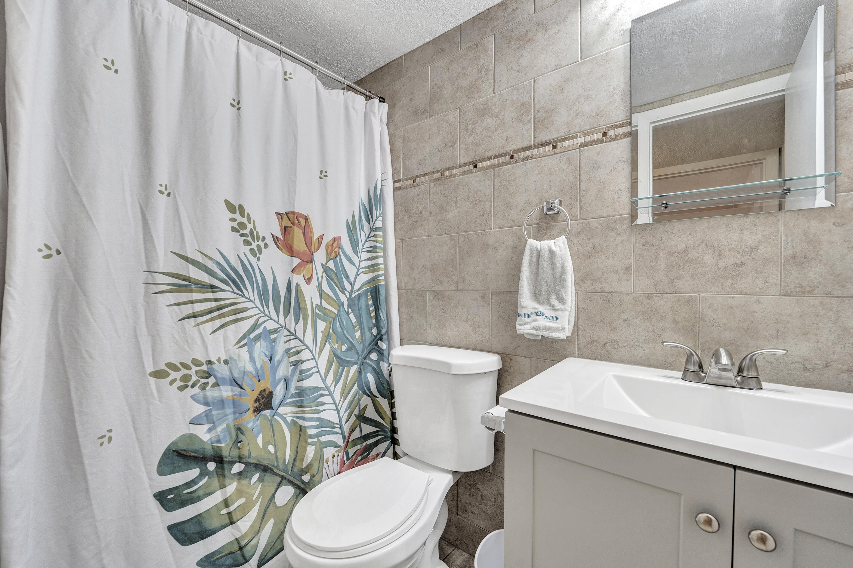 1129 Pebble Beach Lane, Unit 6 Marathon, FL 33050 - Photo 15 of 31 a bathroom with a sink a toilet and shower curtain