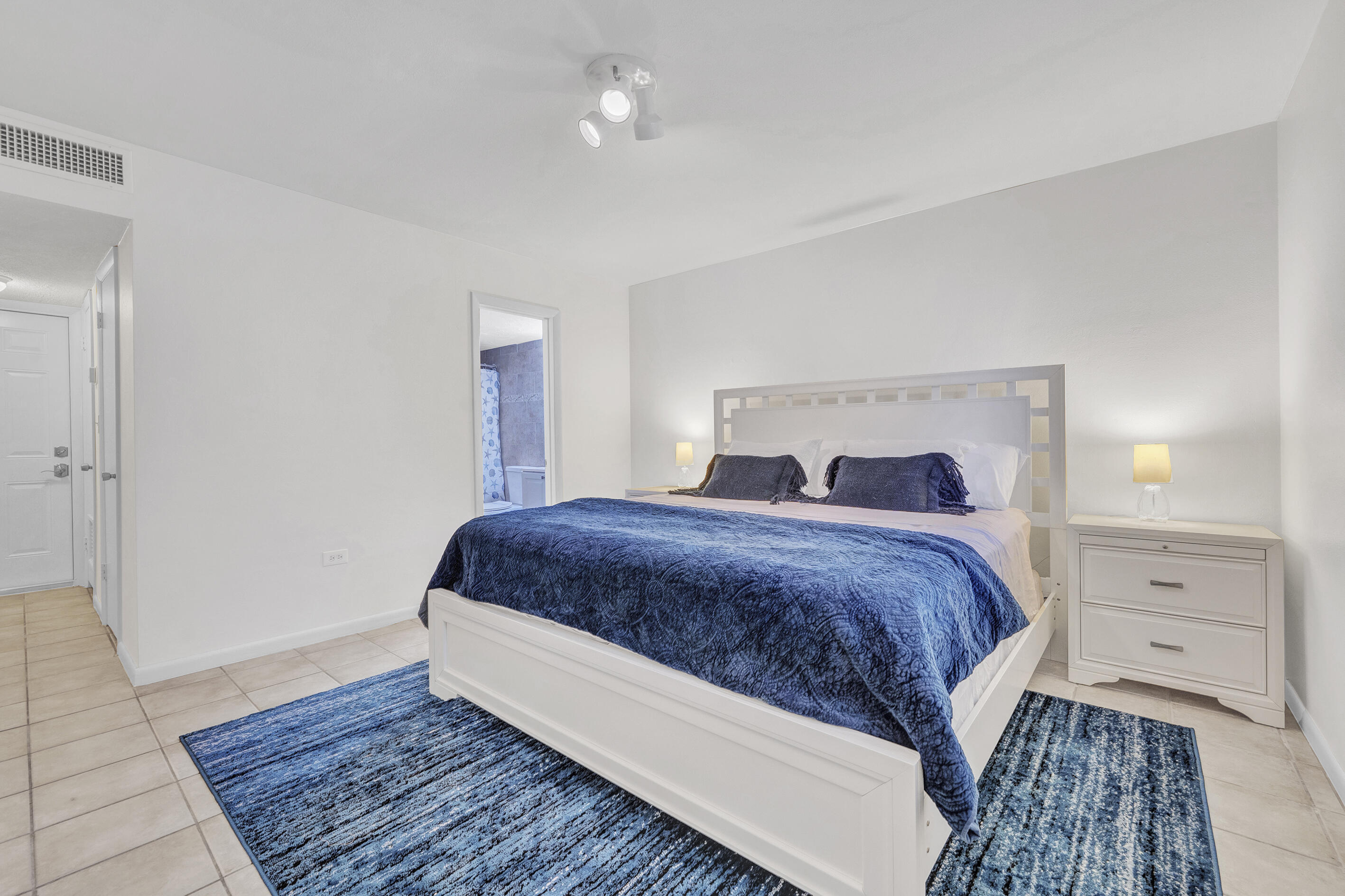 1129 Pebble Beach Lane, Unit 6 Marathon, FL 33050 - Photo 16 of 31 a bedroom with a bed and wooden floor