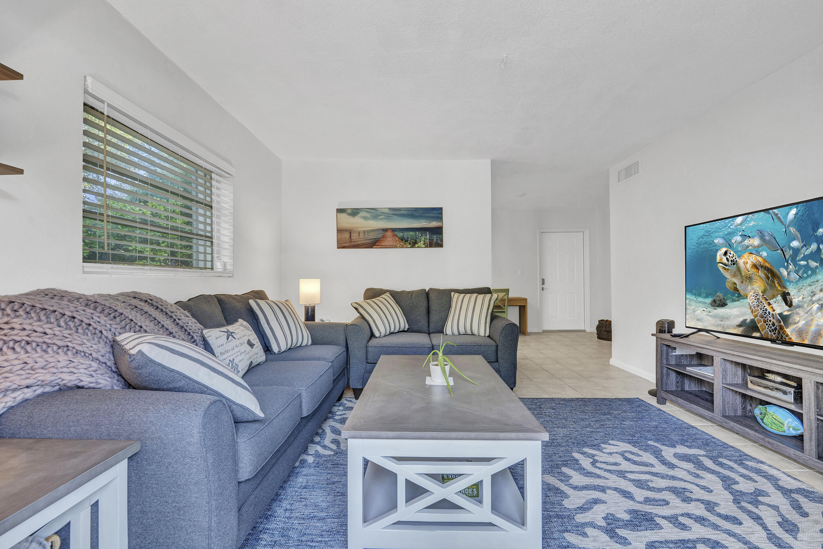1129 Pebble Beach Lane, Unit 6 Marathon, FL 33050 - Photo 3 of 31 a living room with furniture and a flat screen tv