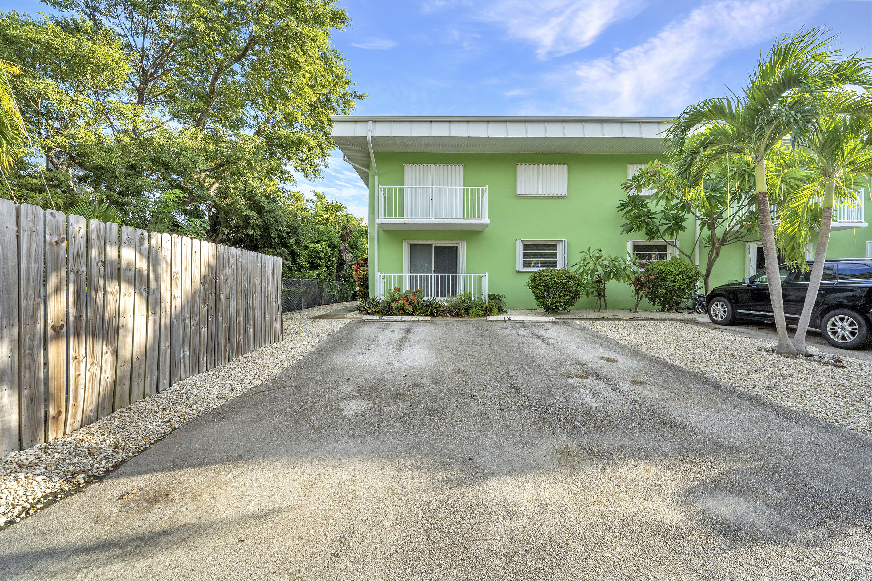 1129 Pebble Beach Lane, Unit 6 Marathon, FL 33050 - Photo 31 of 31 a view of a house with a small yard and a large tree