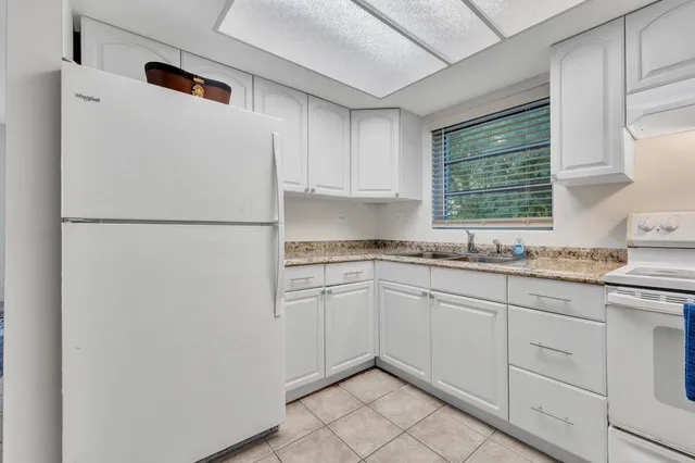a white refrigerator freezer sitting inside of a kitchen