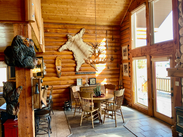 76 Highway 118 Monroe, UT 84754 - Photo 31 of 76 Dining space with healthy amount of natural light, high vaulted ceiling, wooden ceiling, log walls, and wood finished floors