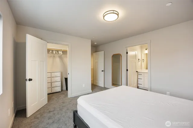 a bedroom with a bed and cabinets