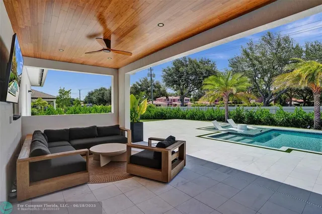 a view of patio with couches and a fire pit