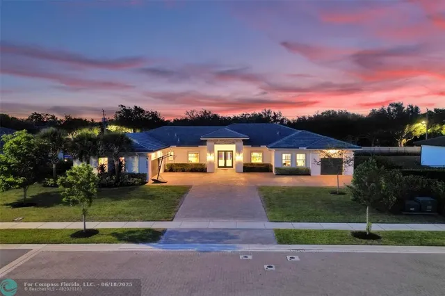 a front view of house with yard and green space