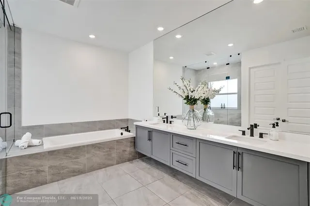 a spacious bathroom with a double vanity sink mirror and