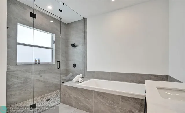 a bathroom with a bathtub and shower