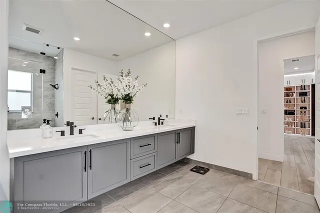 a spacious bathroom with a double vanity sink mirror and