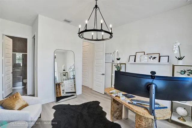 a bedroom with a bed and a chandelier