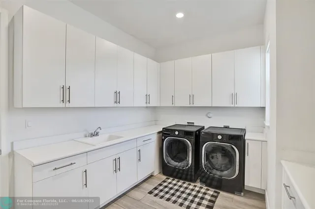 a kitchen with a sink a stove and cabinets