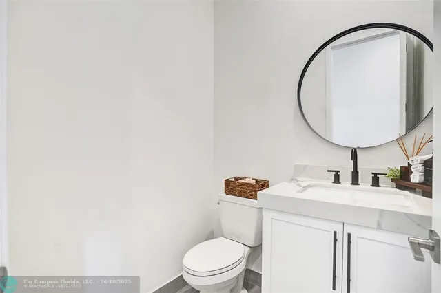 a bathroom with a sink a toilet and a mirror