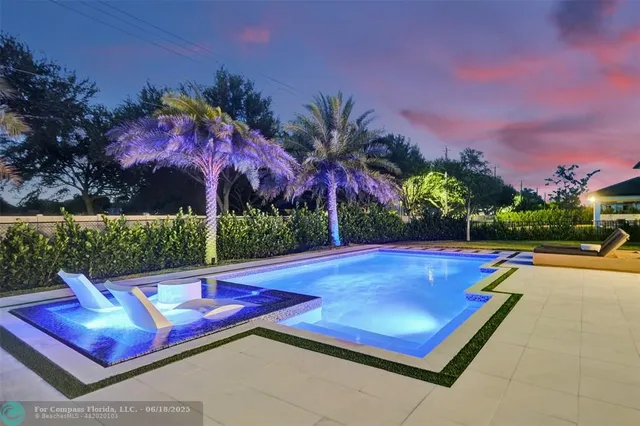 a view of swimming pool with a lounge chairs