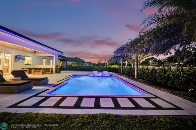 a view of swimming pool with outdoor seating