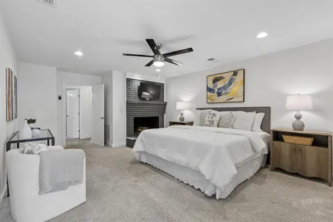 a spacious bedroom with a bed and a chandelier