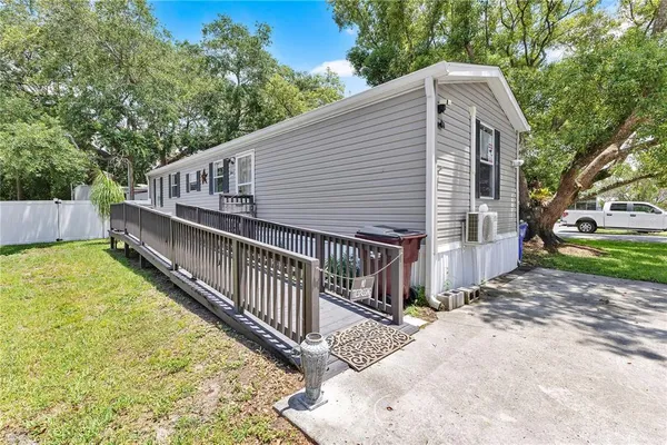 a view of a house with backyard and sitting area