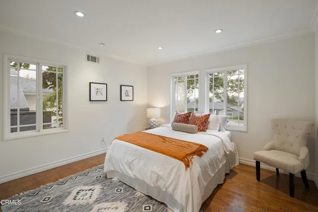 a view of a house with backyard garden and sitting area
