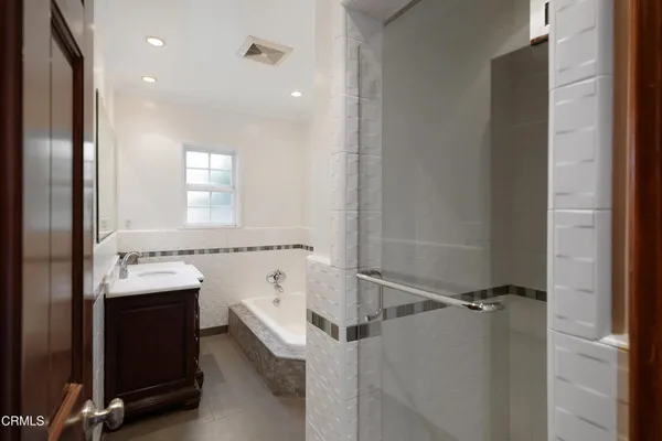 a bedroom with a bed and a large mirror