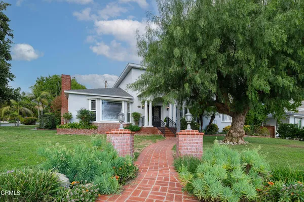 a front view of house with yard and green space