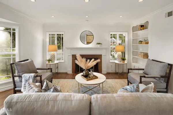 a living room with furniture and a fireplace
