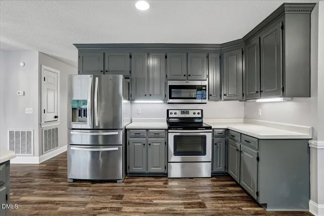 a view of a kitchen with a sink a refrigerator and window