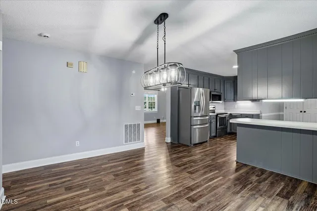 a kitchen with stainless steel appliances and wooden cabinets