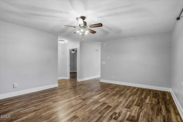 a kitchen with stainless steel appliances granite countertop a refrigerator a stove a sink and a wooden floors