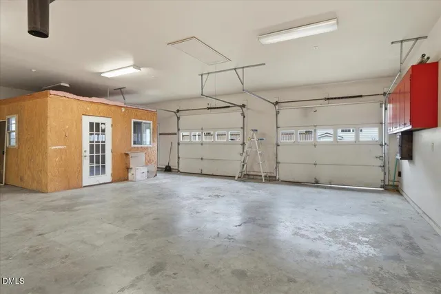 a view of house with garden space and sitting area