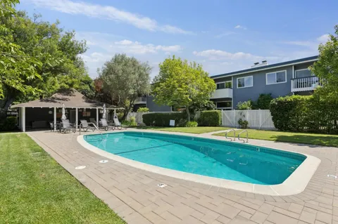 a view of a house with swimming pool and yard