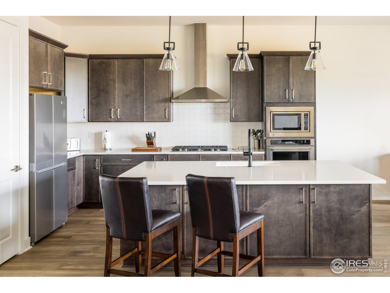 2940 Newfound Lk Road Berthoud, CO 80513 - Photo 11 of 42 a kitchen with a table chairs refrigerator and microwave
