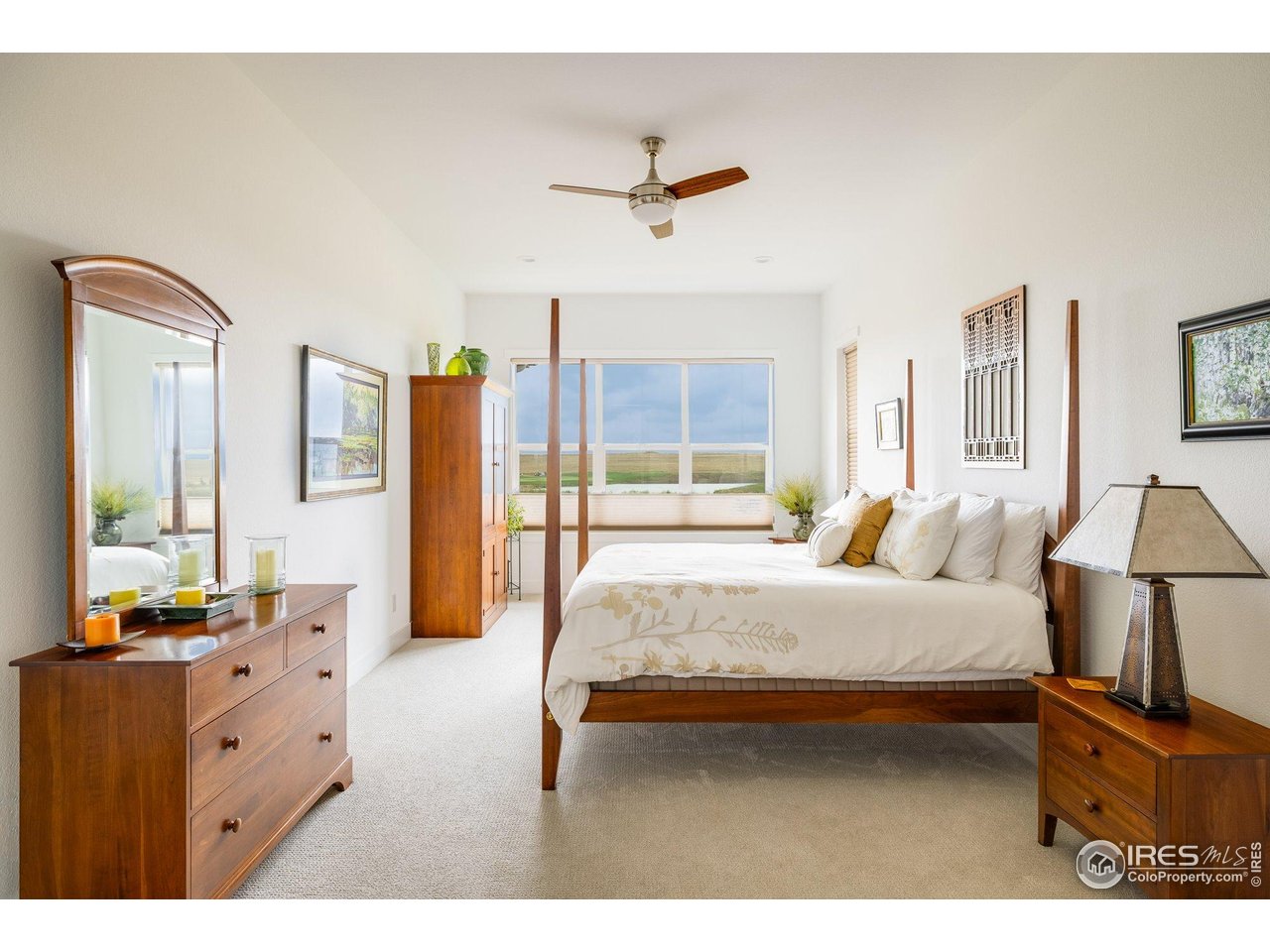 2940 Newfound Lk Road Berthoud, CO 80513 - Photo 15 of 42 a spacious bedroom with a bed a dresser and a large mirror