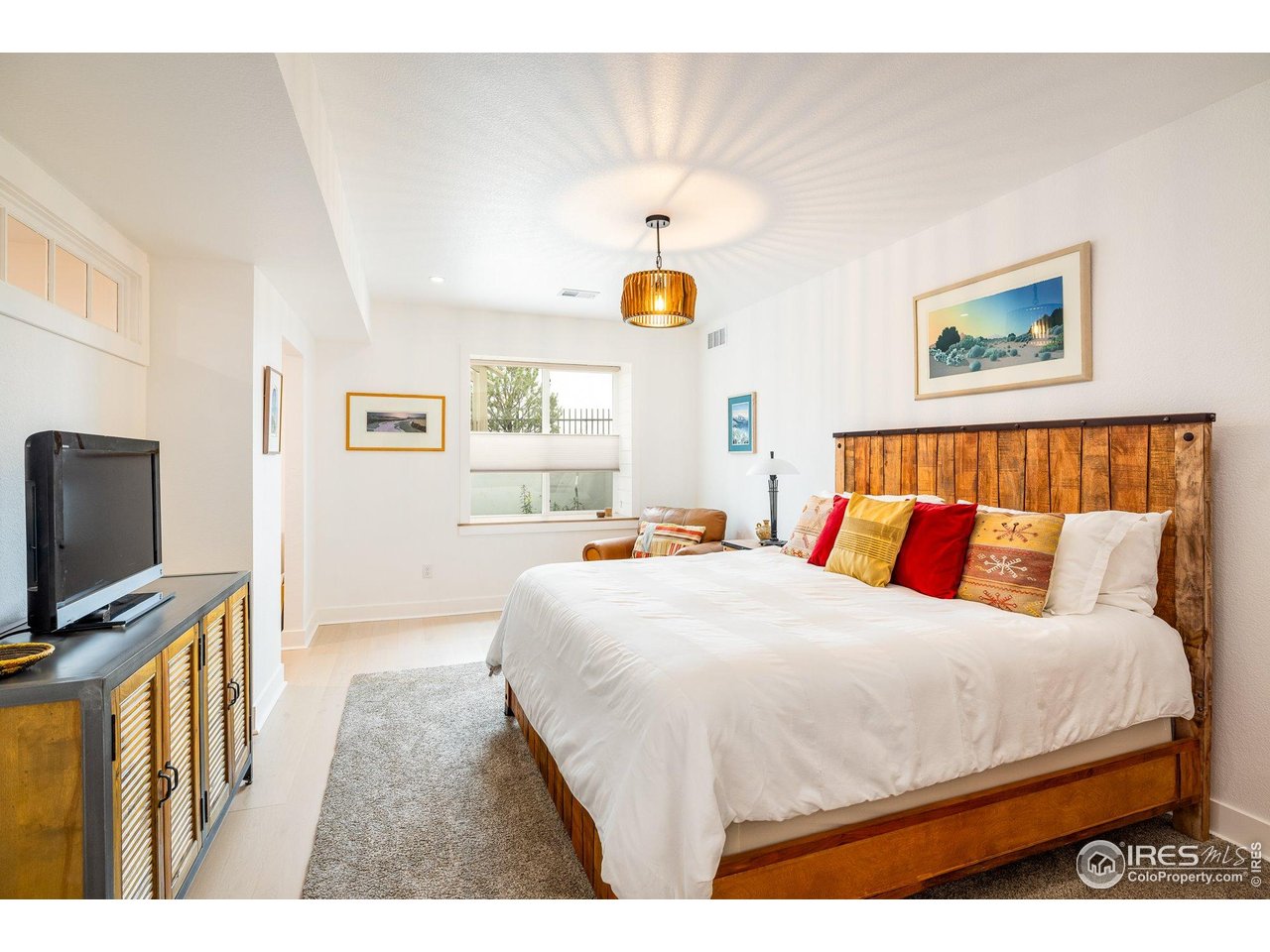 2940 Newfound Lk Road Berthoud, CO 80513 - Photo 27 of 42 a bedroom with a bed a flat screen tv and a window