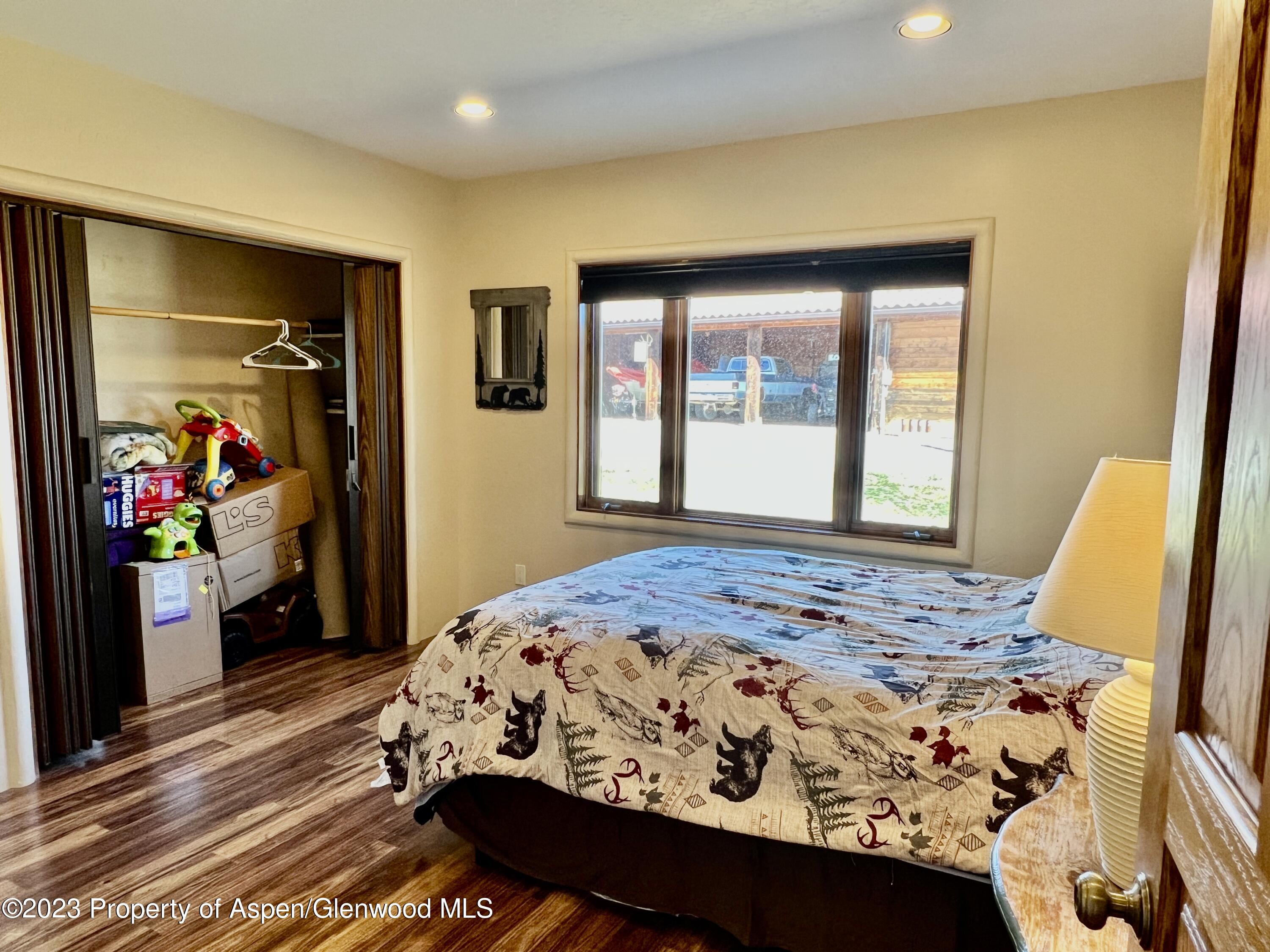 1007 Mesa Drive Rifle, CO 81650 - Photo 13 of 27 a bedroom with a bed and wooden floor