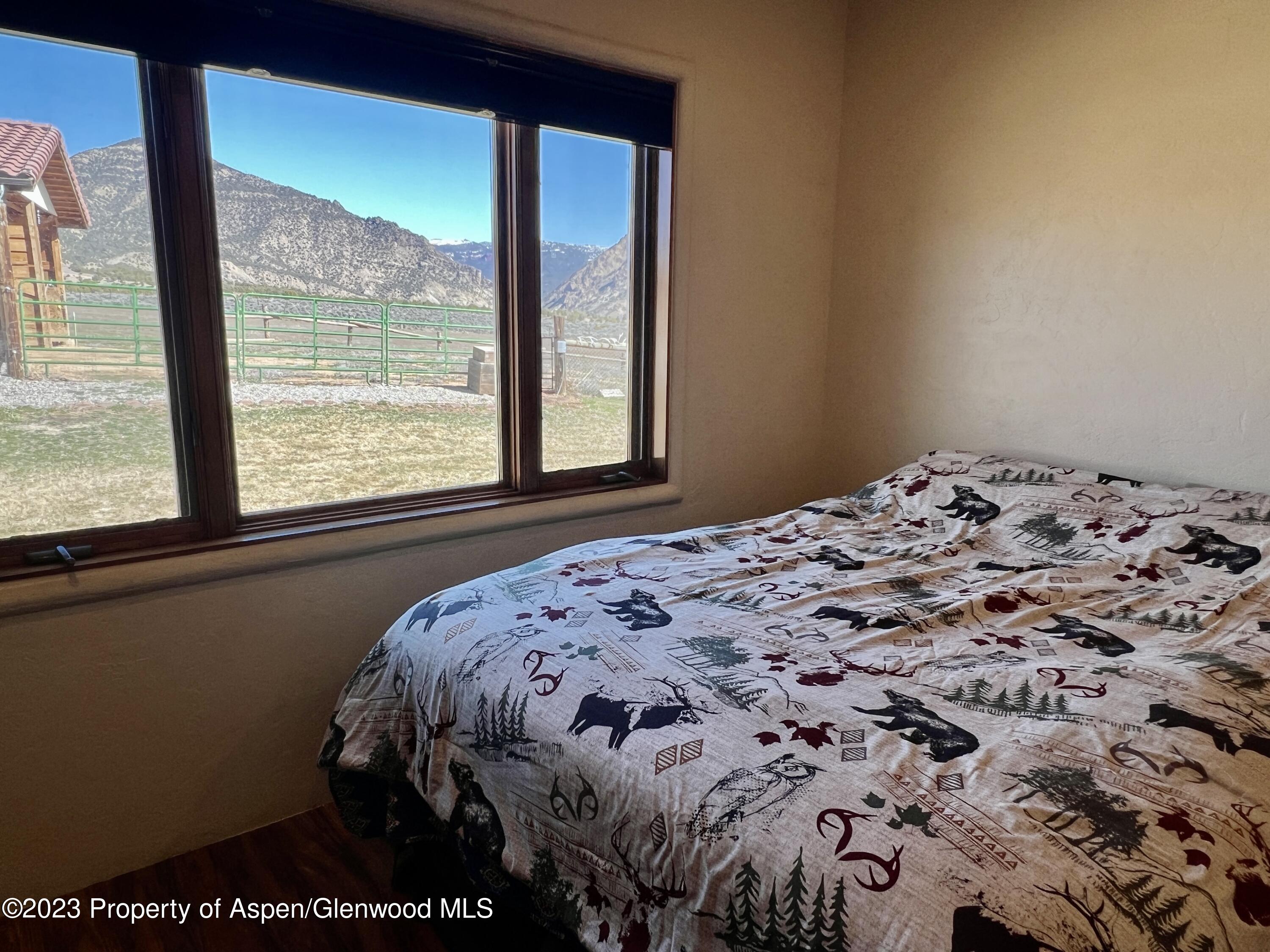 1007 Mesa Drive Rifle, CO 81650 - Photo 14 of 27 a bedroom with a bed and a window
