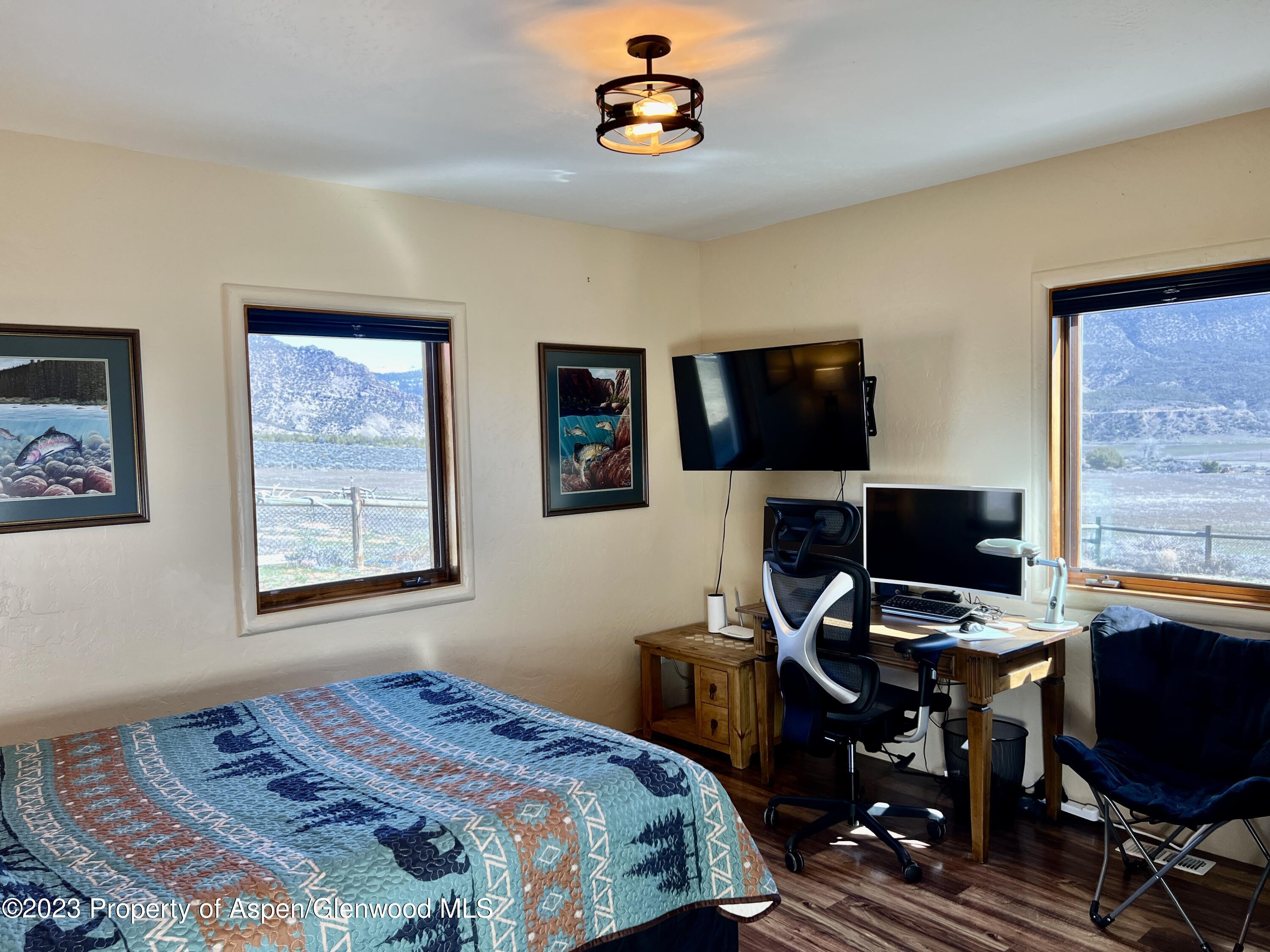 1007 Mesa Drive Rifle, CO 81650 - Photo 20 of 27 a bedroom that has a bed and a desk
