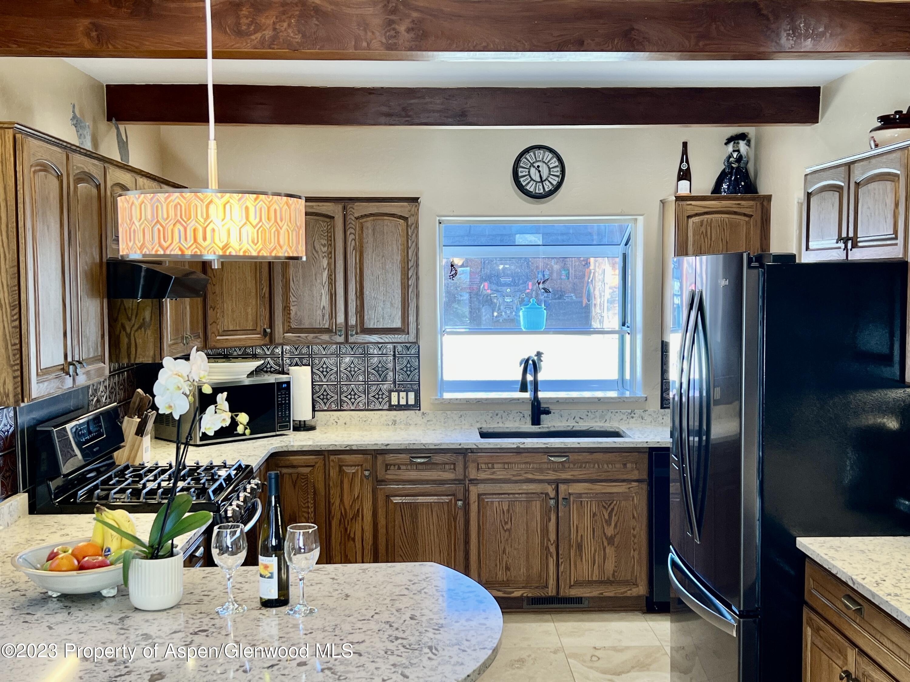 1007 Mesa Drive Rifle, CO 81650 - Photo 6 of 27 a kitchen with stainless steel appliances granite countertop a sink a stove and a refrigerator