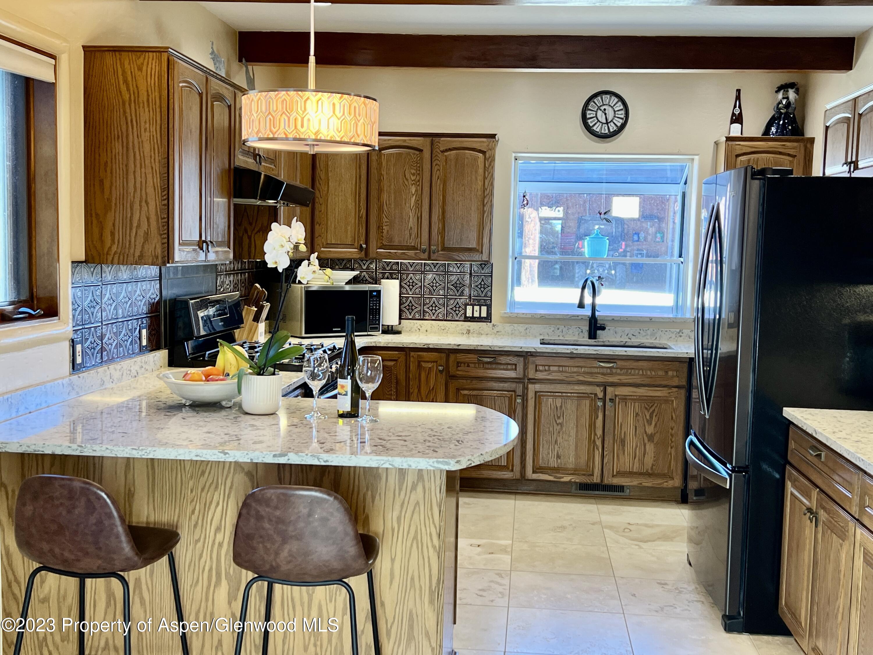 1007 Mesa Drive Rifle, CO 81650 - Photo 7 of 27 a kitchen with stainless steel appliances granite countertop a sink a stove and a refrigerator
