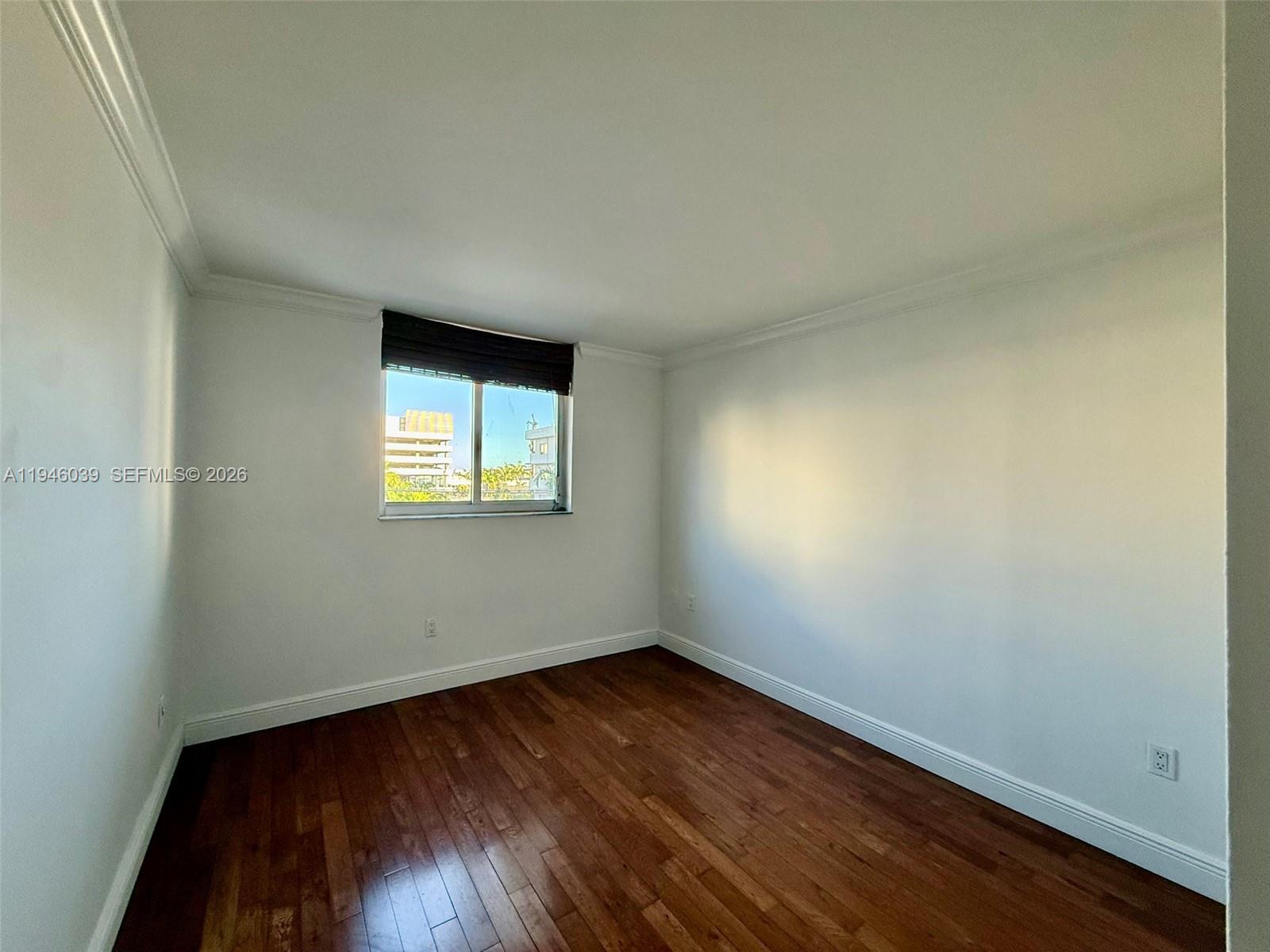 1605 Bay Road, Unit 407 Miami Beach, FL 33139 - Photo 19 of 31 an empty room with a hardwood and a window