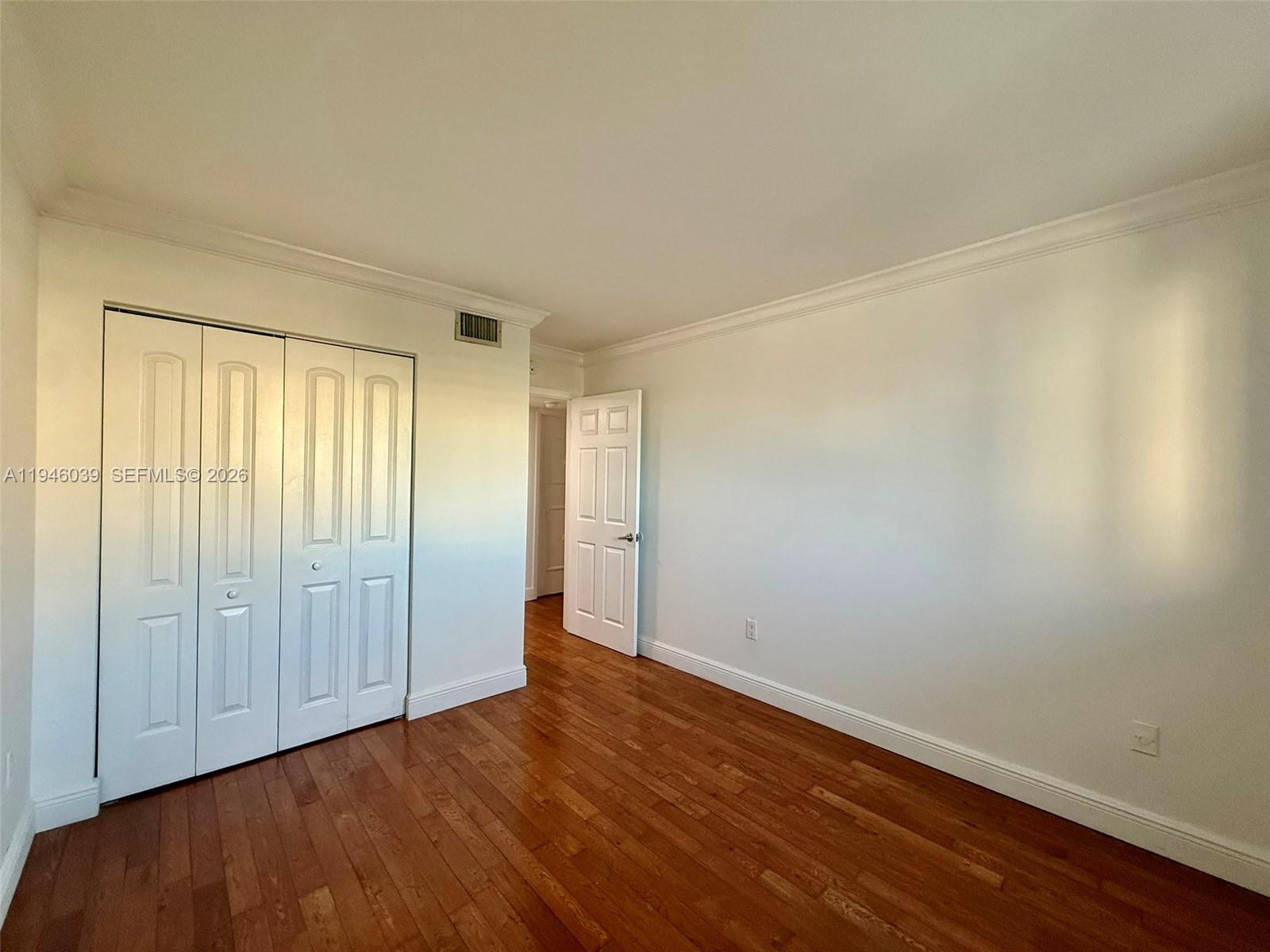 1605 Bay Road, Unit 407 Miami Beach, FL 33139 - Photo 21 of 31 a view of an empty room with wooden floor