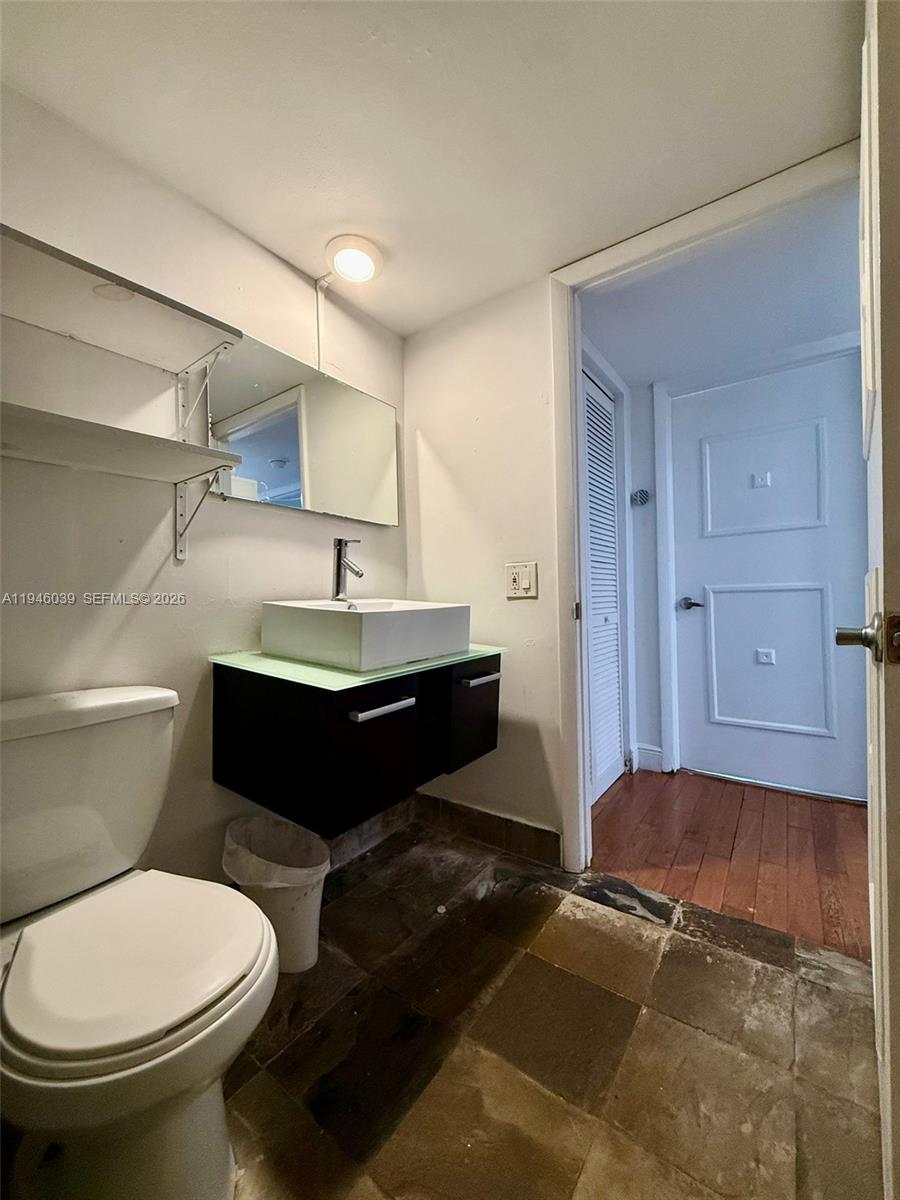 1605 Bay Road, Unit 407 Miami Beach, FL 33139 - Photo 23 of 31 a bathroom with a sink and a toilet