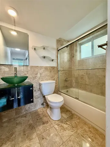 a bathroom with a toilet and a mirror