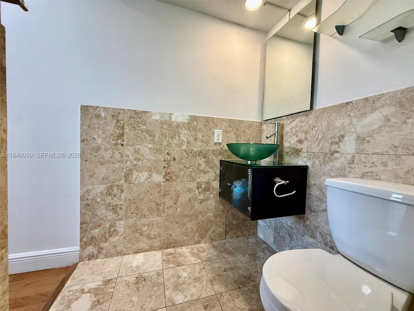 1605 Bay Road, Unit 407 Miami Beach, FL 33139 - Photo 31 of 31 a bathroom with a toilet and a mirror